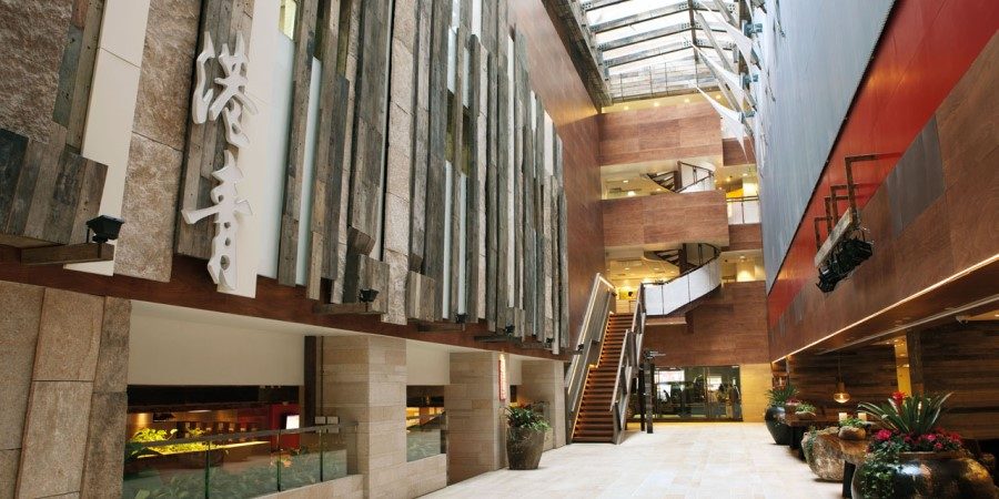 A modern hotel atrium featuring sleek design and contemporary furnishings, creating an inviting atmosphere.